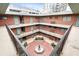 Upper view of landscaped courtyard with decorative fountain and multi-story apartment balconies at 91 Rumson Rd, Atlanta, GA 30305
