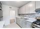 Updated kitchen with modern appliances, stone countertops, and mosaic tile backsplash at 91 Rumson Rd, Atlanta, GA 30305