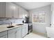Updated kitchen featuring stone countertops, stainless steel appliances, and modern tile backsplash at 91 Rumson Rd, Atlanta, GA 30305