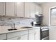 Updated kitchen featuring stone countertops, stainless steel appliances, and modern backsplash at 91 Rumson Rd, Atlanta, GA 30305
