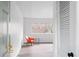Bright living room featuring hardwood floors, white walls and a modern orange chair at 91 Rumson Rd, Atlanta, GA 30305