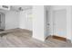 Sunlit living room with light hardwood floors, freshly painted white walls and modern ceiling fixture at 91 Rumson Rd, Atlanta, GA 30305