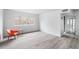 Bright and airy living room, featuring light hardwood floors, white walls, and a modern orange chair and table at 91 Rumson Rd, Atlanta, GA 30305