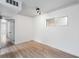 Bright room showcasing light hardwood floors, white walls, a large window, and modern ceiling fixtures at 91 Rumson Rd, Atlanta, GA 30305