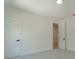 Bedroom with a neutral carpet, white trim, and doors leading to the hallway at 138 Beutell St, Norcross, GA 30071