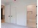 Modern bedroom featuring trim, doors, and entry to a bathroom at 138 Beutell St, Norcross, GA 30071