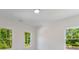 Sun-lit bedroom featuring three large windows overlooking a lush green landscape at 138 Beutell St, Norcross, GA 30071