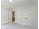 Bedroom with a neutral carpet and white trim, two doors, and a light fixture at 138 Beutell St, Norcross, GA 30071