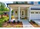 Inviting front porch with elegant columns, brick accents, and professionally landscaped garden beds at 138 Beutell St, Norcross, GA 30071