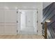 Hallway with wainscoting, hardwood flooring and doorway into the next room at 138 Beutell St, Norcross, GA 30071