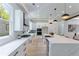 Modern kitchen with white cabinets, granite countertops, stainless steel appliances, and wood flooring at 138 Beutell St, Norcross, GA 30071