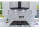 Bright kitchen features stainless steel range, modern vent hood, marble backsplash, and ample countertop space at 138 Beutell St, Norcross, GA 30071