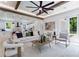 Bright living room with exposed ceiling beams, white interior, large windows, and seamless flow to kitchen at 138 Beutell St, Norcross, GA 30071