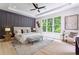 The main bedroom features a decorative accent wall, large windows, and plenty of natural light at 138 Beutell St, Norcross, GA 30071