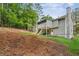 Rear exterior showcasing a spacious backyard, deck, and stairs, perfect for outdoor enjoyment and entertaining at 300 Rocky Cove Trl, Lawrenceville, GA 30044