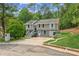 Inviting two-story home with gray siding, white trim, and a spacious front yard with mature trees at 300 Rocky Cove Trl, Lawrenceville, GA 30044