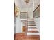 Inviting foyer features hardwood floors, a staircase with decorative iron railings, and a stylish light fixture at 300 Rocky Cove Trl, Lawrenceville, GA 30044