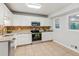 Bright kitchen with white cabinets, stainless steel appliances, and granite countertops at 300 Rocky Cove Trl, Lawrenceville, GA 30044