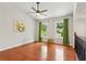 Bright living room with hardwood floors, vaulted ceilings, a ceiling fan, and staircase with decorative railing at 300 Rocky Cove Trl, Lawrenceville, GA 30044