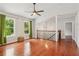 Spacious living room with hardwood floors, a ceiling fan, and natural light at 300 Rocky Cove Trl, Lawrenceville, GA 30044