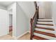The staircase features wooden stairs and a black wrought iron railing with a landing in the background at 300 Rocky Cove Trl, Lawrenceville, GA 30044
