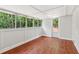 Bright sunroom with hardwood floors and views of a wooded area at 300 Rocky Cove Trl, Lawrenceville, GA 30044
