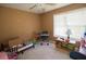 A bedroom features a ceiling fan, a window, and some items lying around at 501 Textbook Ct, Lawrenceville, GA 30044