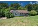 Charming single-story home with a cozy front porch and a well-manicured lawn surrounded by lush trees at 501 Textbook Ct, Lawrenceville, GA 30044
