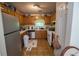Functional kitchen with stainless steel refrigerator, wood cabinets, and ample countertop space at 501 Textbook Ct, Lawrenceville, GA 30044