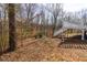 Beautiful backyard with lush trees and access to the home's spacious deck at 1931 Amber Dawn Way, Lawrenceville, GA 30043