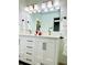 Bathroom featuring a double vanity, updated fixtures, and a large mirror at 1931 Amber Dawn Way, Lawrenceville, GA 30043