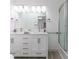 Bright bathroom featuring a double vanity and glass enclosed shower at 1931 Amber Dawn Way, Lawrenceville, GA 30043