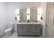 Modern bathroom featuring double sinks, gray vanity, and stylish lighting fixtures at 1931 Amber Dawn Way, Lawrenceville, GA 30043