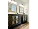 Charming bathroom with double vanities, framed mirrors, decorative cabinet inlays, and wood flooring at 1931 Amber Dawn Way, Lawrenceville, GA 30043