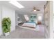 Spacious bedroom with skylight, ceiling fan, and large bed with blue accents at 1931 Amber Dawn Way, Lawrenceville, GA 30043