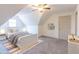 Attic bedroom with vaulted ceilings featuring plush carpet, modern decor, and natural light at 1931 Amber Dawn Way, Lawrenceville, GA 30043