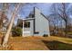 Side view of a blue two-story home with a stone chimney and a covered front porch at 1931 Amber Dawn Way, Lawrenceville, GA 30043