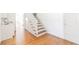Hallway with hardwood floors, staircase, and a wet bar area with ample storage at 1931 Amber Dawn Way, Lawrenceville, GA 30043