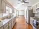 Open kitchen features granite countertops, stainless steel appliances and hardwood floors at 1931 Amber Dawn Way, Lawrenceville, GA 30043