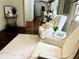 Hardwood floors and two elegant armchairs lead to the kitchen/dining area at 1931 Amber Dawn Way, Lawrenceville, GA 30043