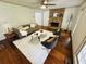 Living room with stone fireplace, hardwood floors, modern seating, and ample natural light at 1931 Amber Dawn Way, Lawrenceville, GA 30043