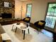 Bright living room featuring a stone fireplace, ceiling fan, and hardwood floors at 1931 Amber Dawn Way, Lawrenceville, GA 30043