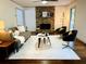 Cozy living room with a stone fireplace, ceiling fan, and stylish decor at 1931 Amber Dawn Way, Lawrenceville, GA 30043