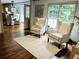 Hardwood floors and two elegant armchairs lead to the kitchen/dining area at 1931 Amber Dawn Way, Lawrenceville, GA 30043