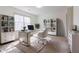 Modern office space with bright lighting, stylish desk, matching white shelving, and view of wooded outdoors at 1931 Amber Dawn Way, Lawrenceville, GA 30043