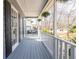 Cozy front porch featuring a porch swing, white railing, and hanging ferns, perfect for relaxing at 1931 Amber Dawn Way, Lawrenceville, GA 30043