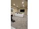 Finished basement with plush carpeting, a modern white sofa, and large screen TV for entertaining at 1932 River Crest Way, Lawrenceville, GA 30045