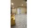 Open basement area with neutral tile flooring, a storage cabinet, and a door leading to another room at 1932 River Crest Way, Lawrenceville, GA 30045