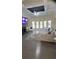 Open living room with large windows, ceiling fan, fireplace and a gray sofa at 1932 River Crest Way, Lawrenceville, GA 30045