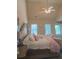 Bright primary bedroom featuring vaulted ceilings, plush bedding, and large windows for natural light at 1932 River Crest Way, Lawrenceville, GA 30045